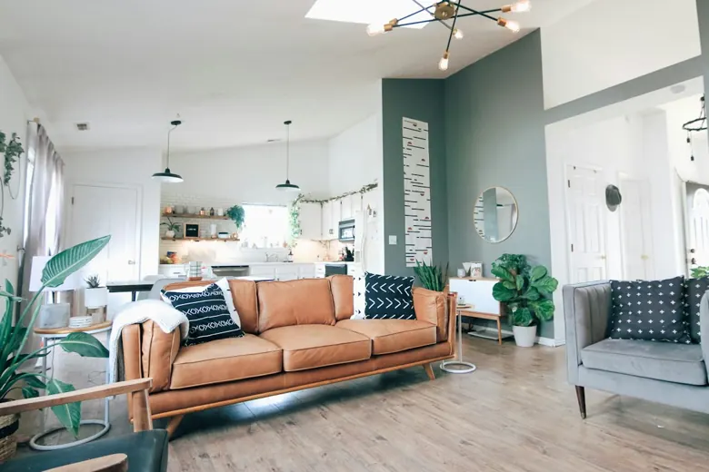 Living room with a tan leather sofa on wood-look plank flooring