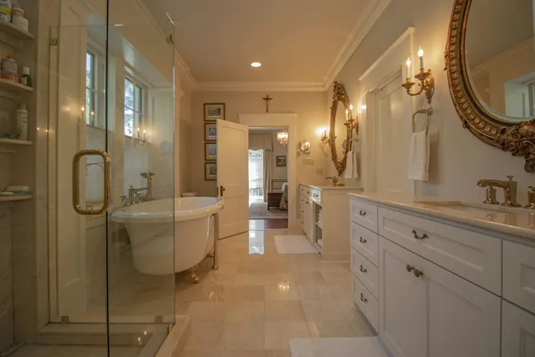 Bathroom with tile flooring, a glass shower and a double vanity